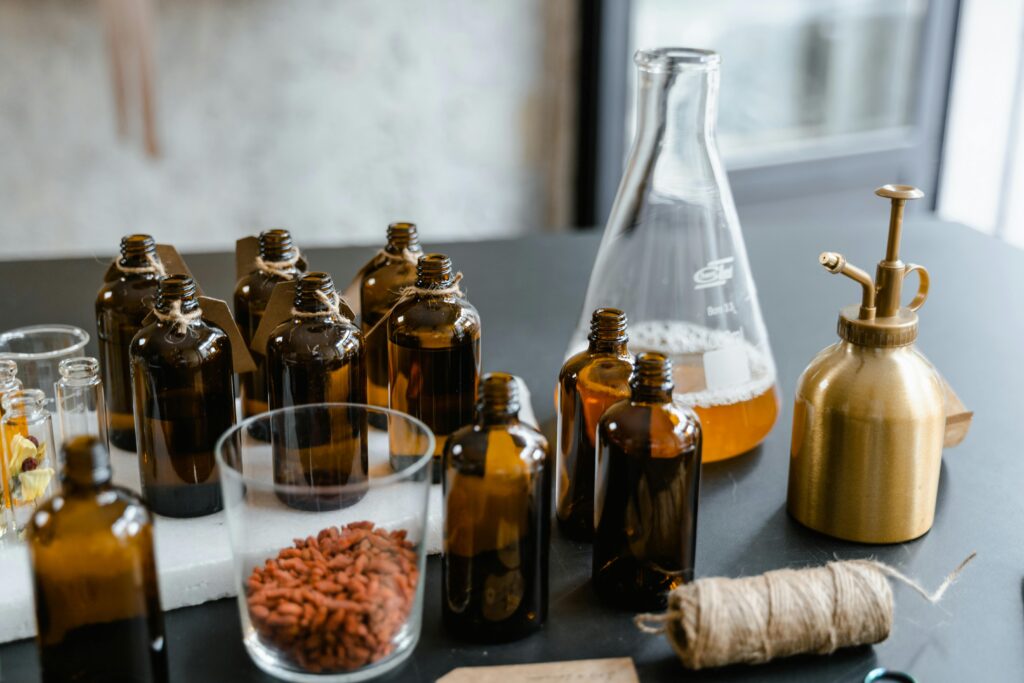 A variety of glass bottles with essential oils and herbs for aromatherapy.