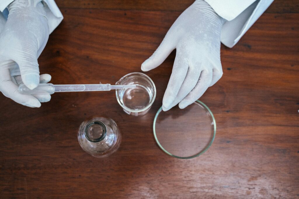 pexels-photo-8392576-8392576 Close-up of a scientist working with lab equipment, wearing gloves, and conducting an experiment.